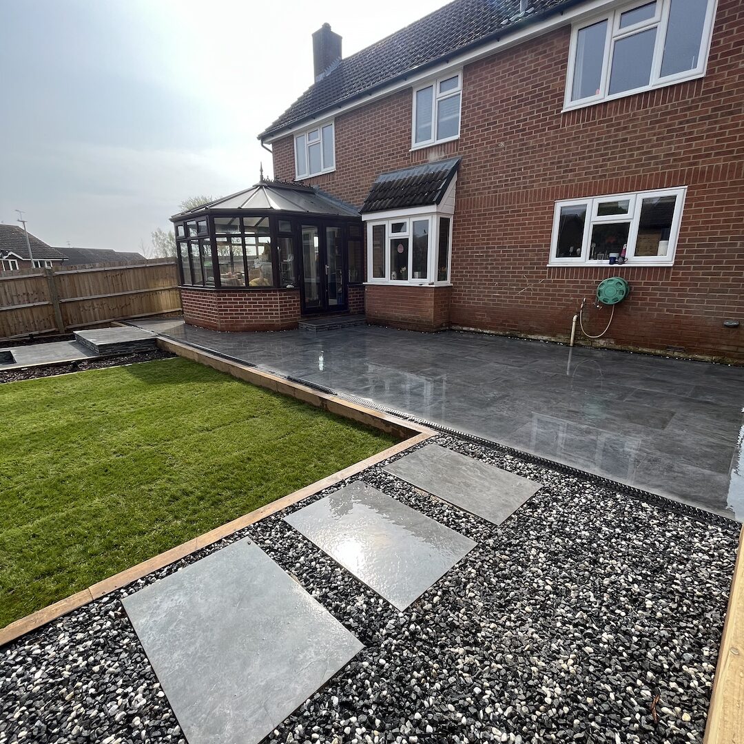 sunny back garden with porcelain patio and gravelled area to the front.
